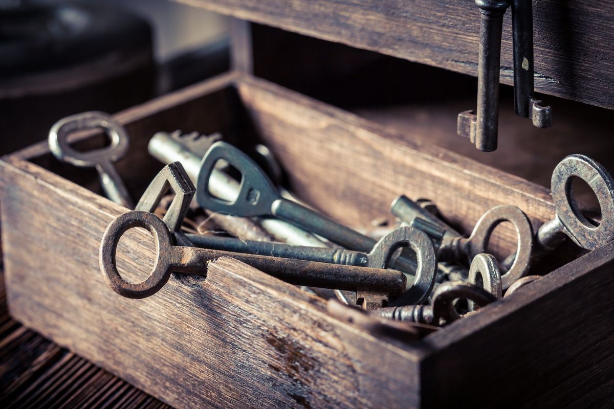 Old keys in wooden box in locksmiths workshop Old keys in wooden box in locksmiths workshop